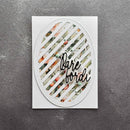 A square white card or plaque with an oval cutout featuring diagonal white slats over a floral pattern, with the words 'Bare Borda' in black script across the center, photographed on a textured dark gray surface.