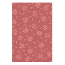 A rectangular sheet of dusty rose pink cardstock featuring a repeating embossed pattern of poinsettias and small holly leaves, shown against a plain white background.