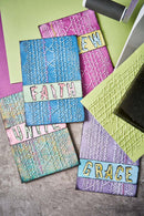 Colorful textured cards with embroidered text on a textured surface