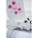 Cricut cutting machine with snowflake designs on a white background