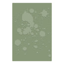 A rectangular stencil or template featuring embossed paint splatter and drip patterns in a light sage green color over a darker olive green background, shown against a plain white backdrop.