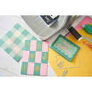 Colorful greeting cards with 'Happy Birthday' text and checkered patterns on a white surface.