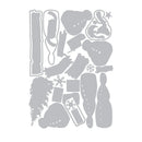 A sheet of gray die-cut craft pieces arranged on a white background, including holiday-themed shapes such as a tree, ornaments, snowflakes, and decorative cutouts.