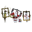 Three Christmas-themed paper cutout decorations displayed on a white background: a reindeer in a gold frame, Santa Claus in a silver frame holding a wreath, and a snowman in a gold frame next to a small wrapped gift.