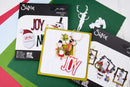Sizix Thinlites Dies holiday crafting kit showing various die-cut paper and metal cutters on a green and white background.