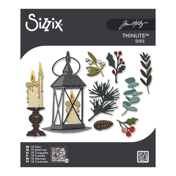 Sizix Thinline Dies by Jim Holtz holiday die set featuring 18 dies for crafting, shown on its retail packaging with sample designs of a candle lantern, pine branches, eucalyptus, and berries.