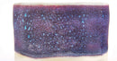 A square ceramic tile or coaster with a textured, glittery surface featuring a gradient of deep purple, blue, and pink with small light blue speckles, set against a plain white background.