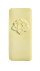 A pale yellow rectangular bar of soap with a raised lotus flower design near the top, shown on a plain white background.
