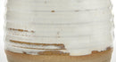 Close-up of a handmade ceramic vase or planter with a textured, ribbed white glaze showing brown clay showing through, and a natural brown base.