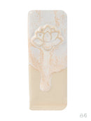 A rectangular ceramic tile or coaster with rounded corners, featuring a glossy white and cream dripped glaze design with a raised lotus flower motif on the upper half.