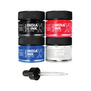 Four small jars of India Ink acrylic paint in black, red, blue, and white, arranged in a 2x2 grid above a clear glass pipette with a black cap, on a white background.