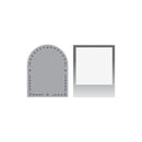 A gray metal die-cutting or stamping template set on a plain white background, featuring an arched frame with decorative leafy borders and a rectangular frame with a blank white center.