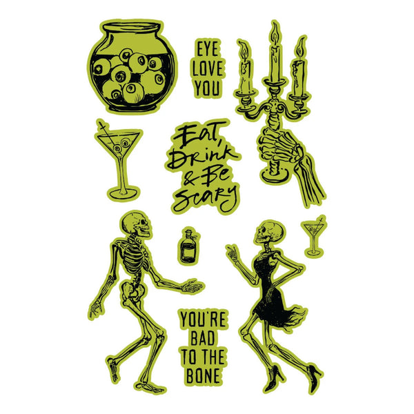A sheet of Halloween-themed rubber stamps or decals featuring skeleton figures, a jar of eyeballs, a martini glass, a candle holder, a bottle, and text phrases like 'Eye Love You,' 'Eat, Drink & Be Scary,' and 'You're Bad to the Bone' on a white background.