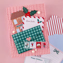 Set of Christmas-themed envelopes and cards on a pink background