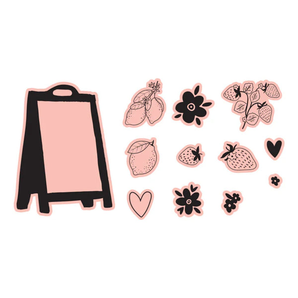 Pink easel with decorative stickers on a white background