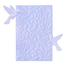 Decorative embossing folder with bird and floral designs on a light blue background