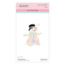 A package of Spellbinders by Bruges crafting cutting dies featuring a cute snowman design. The packaging is white with a pink header and a light blue scalloped stripe, displaying a die-cut illustration of a snowman wearing a black top hat, peach scarf, and mint green scarf.