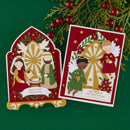 Two red and gold Christmas greeting cards displayed on a dark green background with pine branches and red berries. One card shows a nativity scene with the text 'Glory to God Grace to You,' and the other shows angels with the text 'May angels fill your heart with joy.