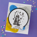 Sticker of Gemini zodiac sign on a purple background with decorative elements