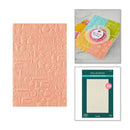 Embossed paper sheet with various patterns, a card with a pink die-cut shape, and Spellbinders packaging on a white background.