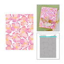 Floral patterned paper, card with butterfly design, and clear stamp set on a white background