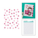 A sheet of pink and red snowflake embellishments shown next to a decorated holiday card featuring a snowman and penguin, with a packaged sheet of matching snowflakes below.