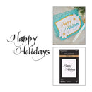 Holiday-themed craft product collage on a white background, featuring the words 'Happy Holidays' in black script, a sample handmade holiday card in turquoise and white with a gold border, and a package of Spellbinders 'Happy Holidays' cardstock.