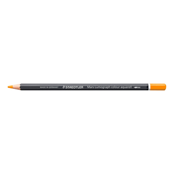 A Staedtler Mary Lumograph colour aquarell drawing pencil in orange, shown horizontally against a plain white background.