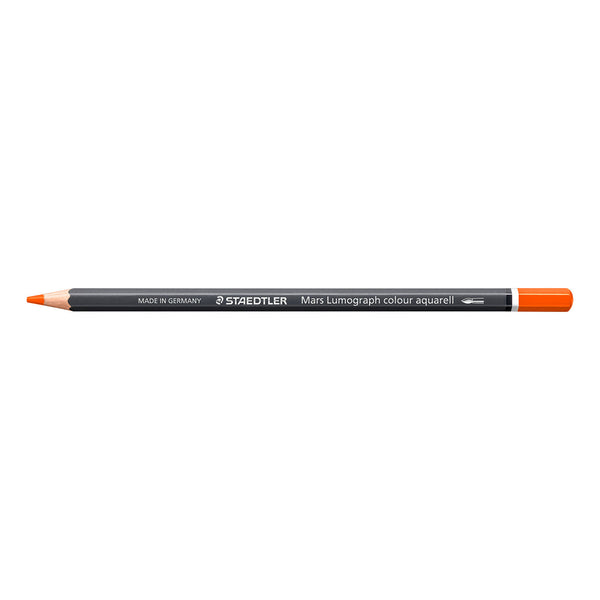 A Staedtler Mary Lumograph colour aquarell drawing pencil in orange, shown horizontally against a plain white background.