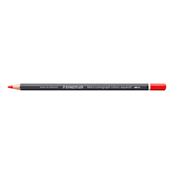 A Staedtler Mary Lumograph colour aquarell drawing pencil in red, shown horizontally against a plain white background.