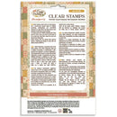 A package of Cozy Families Clear Stamps, featuring a detailed product information card with bilingual English and Spanish text, product descriptions, and a sample stamp design on a patterned beige and brown background.