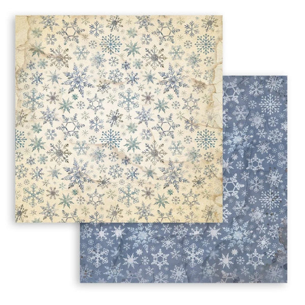Two sheets of paper with snowflake patterns, one beige and one blue.