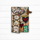 A notebook or journal with a colorful, textured cover featuring cartoon cats, graffiti-style lettering, and the words 'Funky Friends' and 'GILD', shown on a white wood plank background.