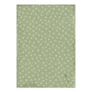 A rectangular sheet of textured paper with a vintage design, featuring a sage green background patterned with small white snowflakes and distressed edges.