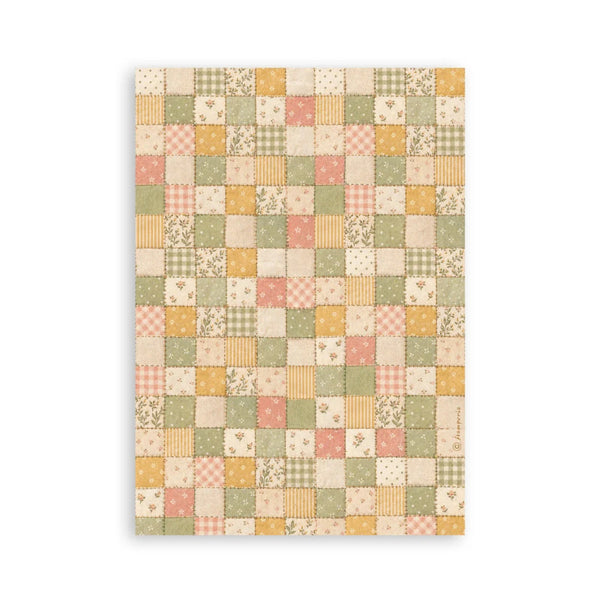 A rectangular fabric or wallpaper panel featuring a vintage patchwork quilt pattern with squares in muted green, peach, mustard yellow, and cream, shown against a plain white background.