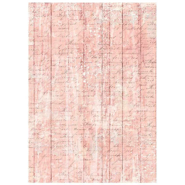 A rectangular area rug with a distressed pink and white faux-wood plank pattern overlaid with faint cursive script, shown flat against a white background.