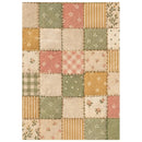 A rectangular patchwork-style rug with a quilted patch design in muted tones of sage green, dusty pink, mustard yellow, and cream, featuring floral, check, stripe, and polka dot patterns.