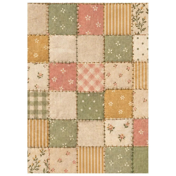 A rectangular patchwork-style rug with a quilted patch design in muted tones of sage green, dusty pink, mustard yellow, and cream, featuring floral, check, stripe, and polka dot patterns.
