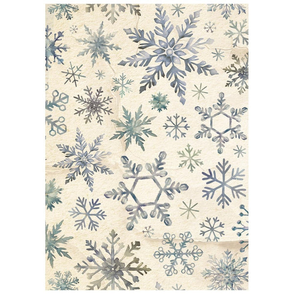 Patterned paper with blue and green snowflake designs on a beige background