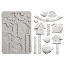 A white silicone baking mold with birdhouse and bird designs, shown next to several corresponding 3D relief sample pieces of the same design on a plain white background.