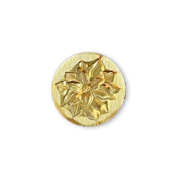 Gold decorative button with floral design on a white background