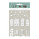 Stamperia Christmas Village cutting dies set in its original packaging, featuring white metal die-cut shapes including houses, a crescent moon, stars, and clouds on a textured beige backing card.
