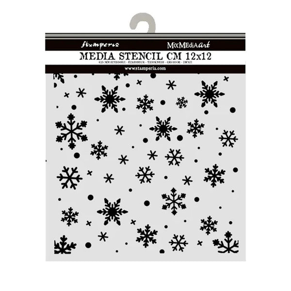 A packaged clear plastic media stencil with black snowflake and dot cutout patterns, shown hanging against a white background. The header card reads 'Stamperia' and 'Media Stencil CM 12x12'.