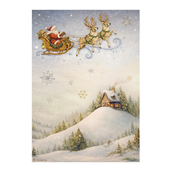 A festive winter landscape print showing Santa Claus in a sleigh pulled by two reindeer flying above a snow-covered hill with a small cabin and evergreen trees. The scene is decorated with snowflakes and has a soft pastel color palette.