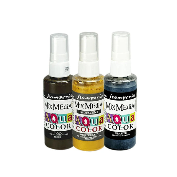 Three small spray bottles of Tim Holten Mix Media Aqua Color ink, shown side by side on a white background. The bottles contain black, gold, and blue ink, with white caps and colorful labels.
