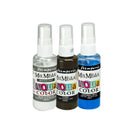 Three small spray bottles of Stampers Mix Media Aqua Color ink on a plain white background. The bottles contain clear, dark brown, and blue liquids, with white caps and colorful labels.