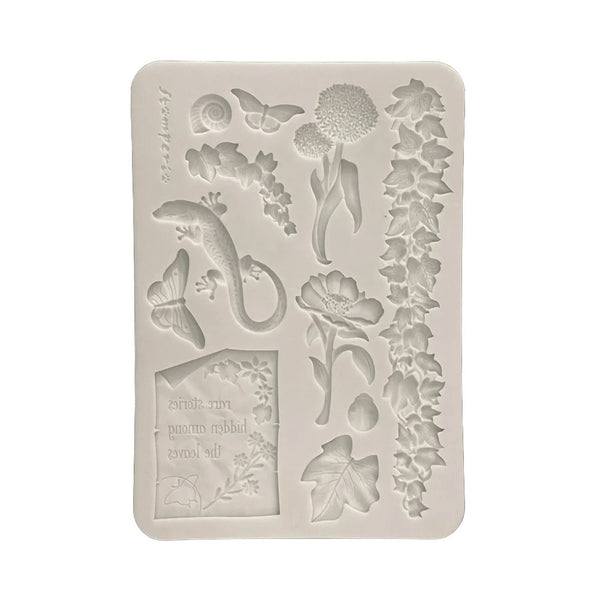 Decorative silicone mold with floral and nature-themed designs on a white background