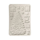 A rectangular silicone mold with embossed Christmas-themed designs, including a large Christmas tree, teddy bear, rocking horse, snowflake, frames, and small decorative motifs, shown on a plain white background.