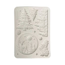 A rectangular white silicone mold with rounded corners, featuring embossed winter forest designs including pine trees, a deer in a moonlit circle, and pinecones, shown on a plain white background.