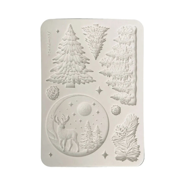 A rectangular white silicone mold with rounded corners, featuring embossed winter forest designs including pine trees, a deer in a moonlit circle, and pinecones, shown on a plain white background.